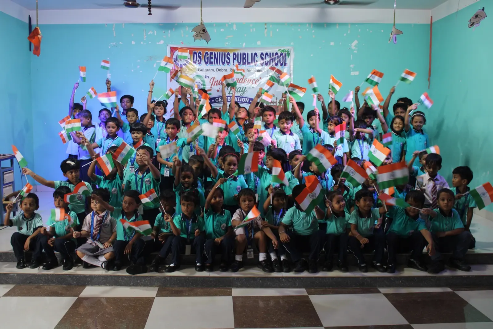 Students of D.S. Genius Public School holding Indian flags at an Independence Day gathering in Golgram, Debra.