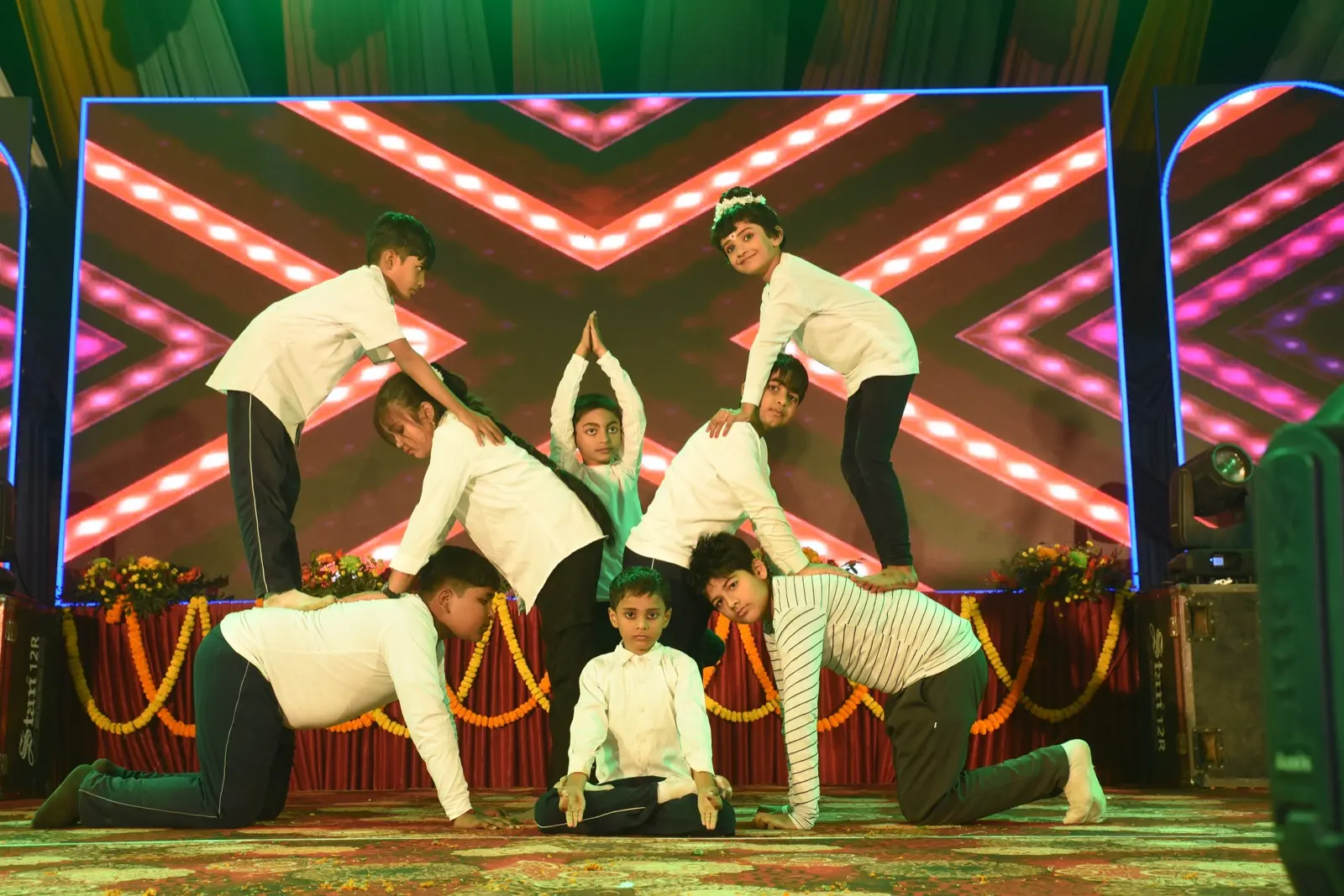Students in a stage performance. The photograph does not show the proposed school building.